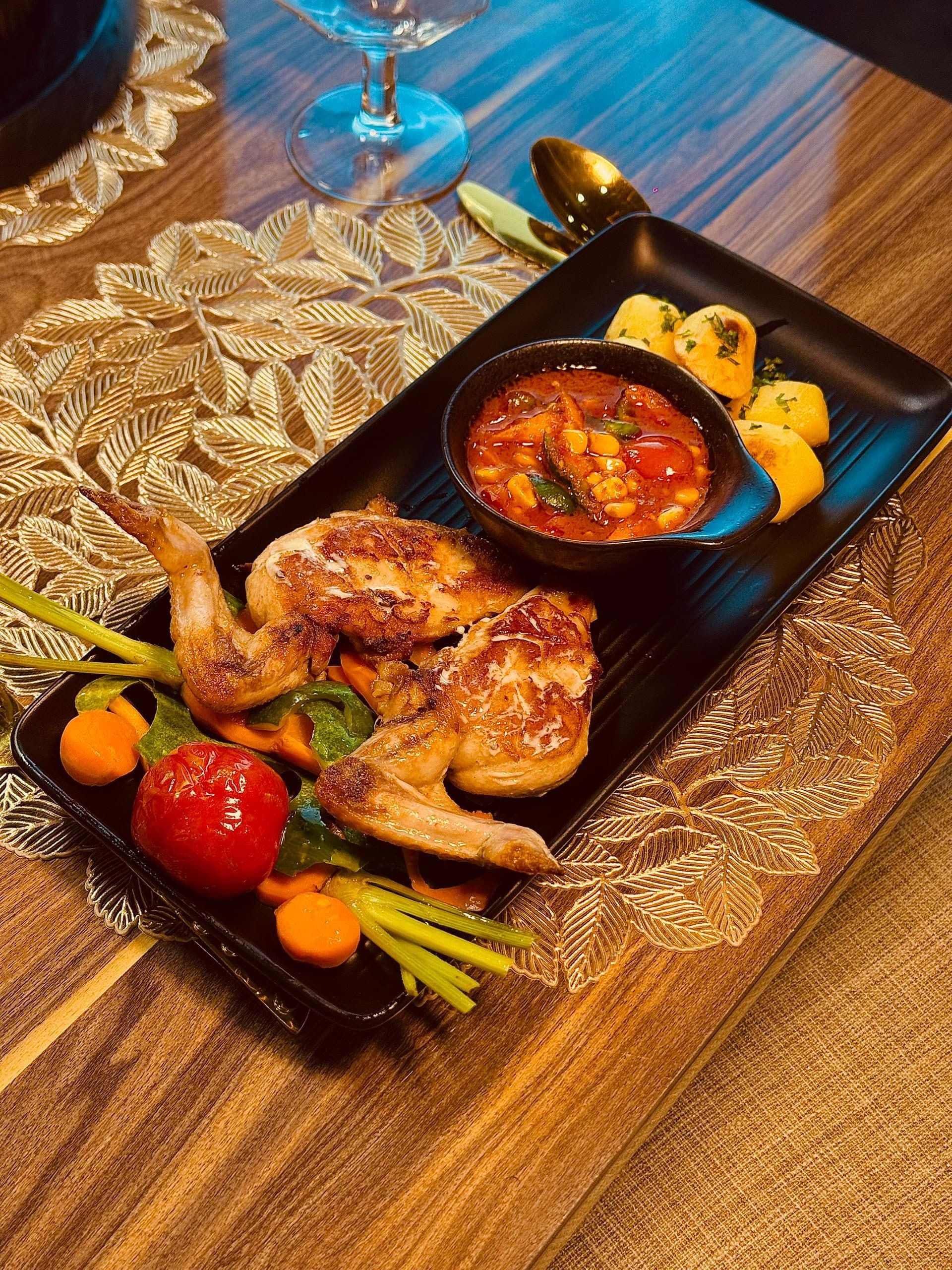 Dining by Ménage — plated quail with gold leaf